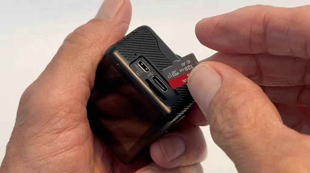 Inserting microSD card into action camera