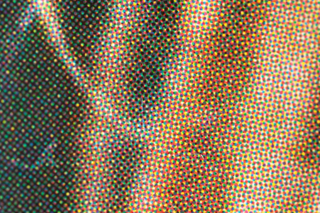 Extreme close-up of halftone ink dots forming a printed image