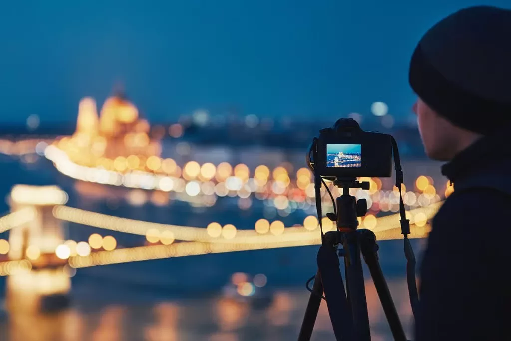 Photographer tripod night cityscape long exposure setup